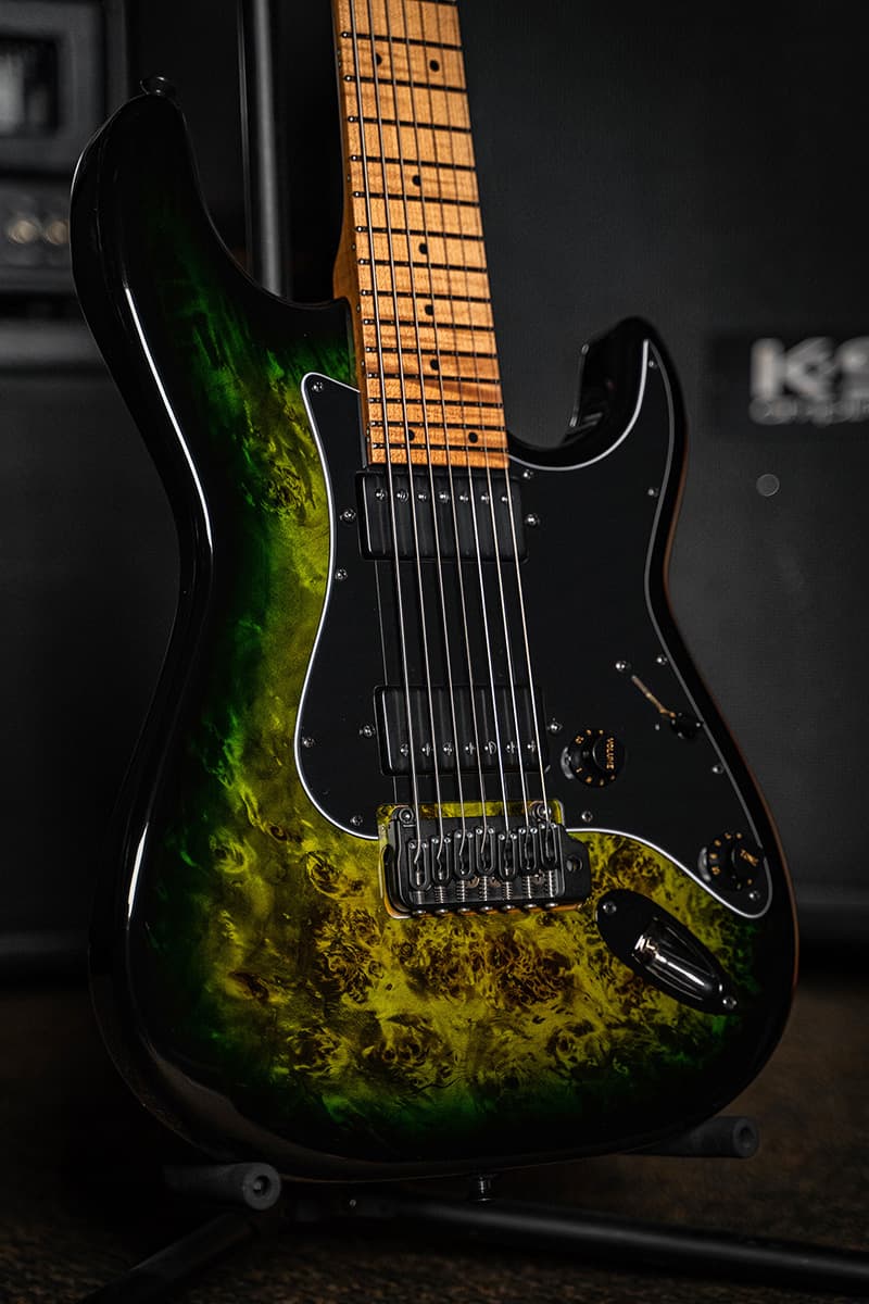 Kiesel Guitars Delos 7 string tremolo D7X with lizard burst finish, black burst edges, black pickguard, black pickup covers, black pickup poles, black plastic knobs, maple fingerboard, black acrylic dot inlays