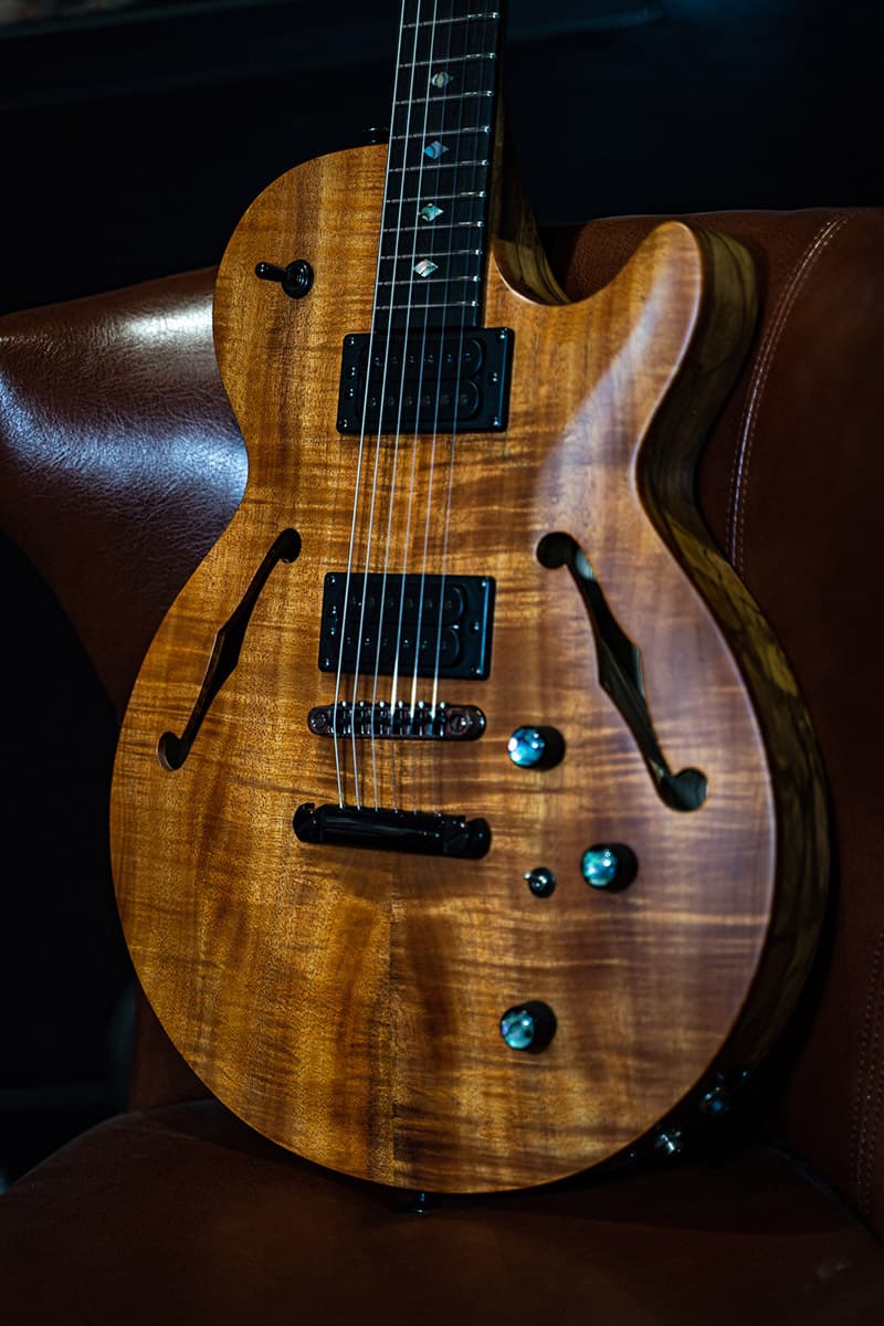 Kiesel Guitars SH550 with koa top, black pickup covers, black bezels, black pole pieces, abalone inlay knobs, black hardware, ebony (less color variation) fingerboard, abalone diamond inlays, midi option SH575