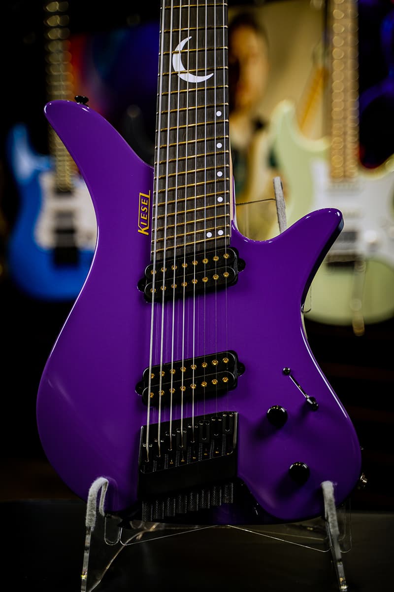 Kiesel Guitars Thanos Guitar TGM8 8 String tremolo with purple finish, alder body, thorium bridge pickup, richlite diamond black fingerboard, gold frets, gold pole pieces, mother of pearl crecent moon w/ staggered offset dot inlays ICSD, drop shadow gold logo, maple neck