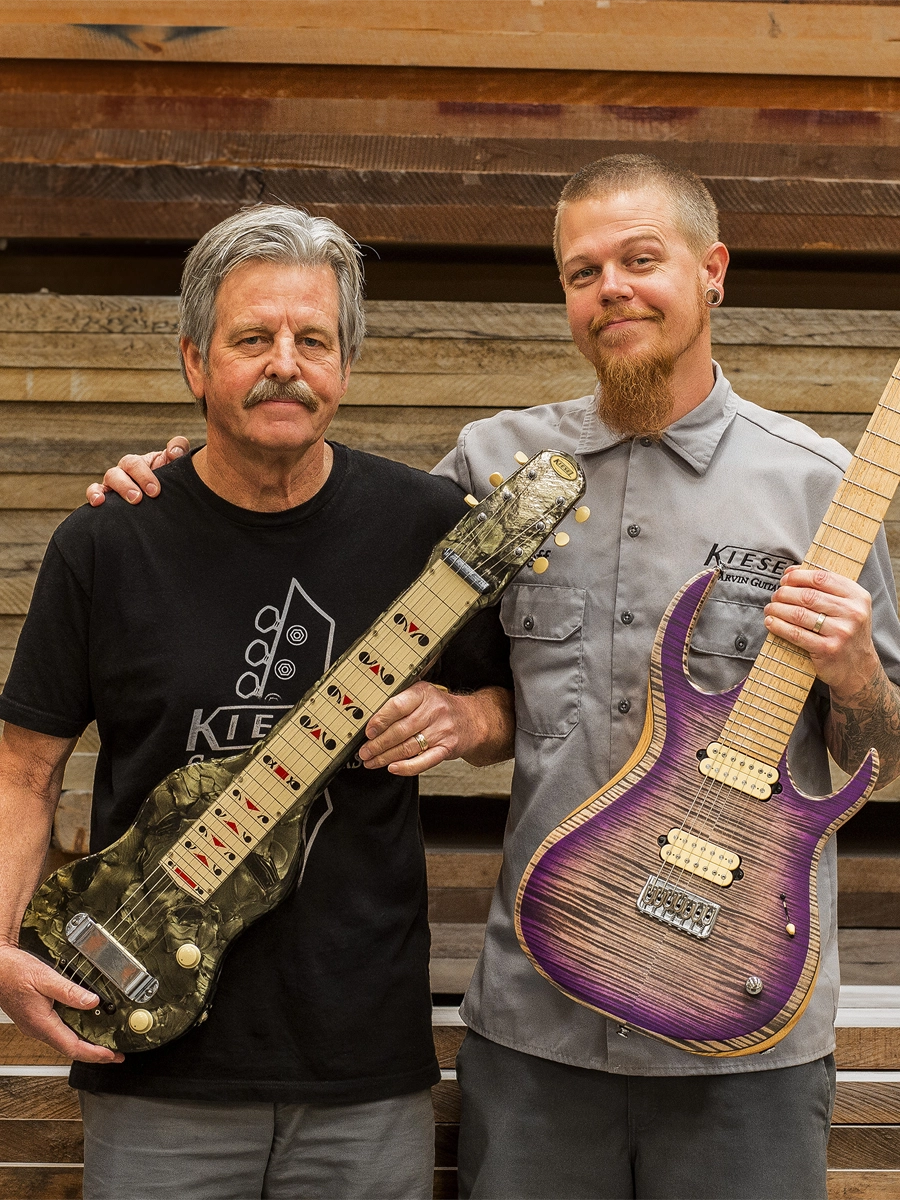 Mark Kiesel and Jeff Kiesel showing off the evolution of Kiesel Guitars